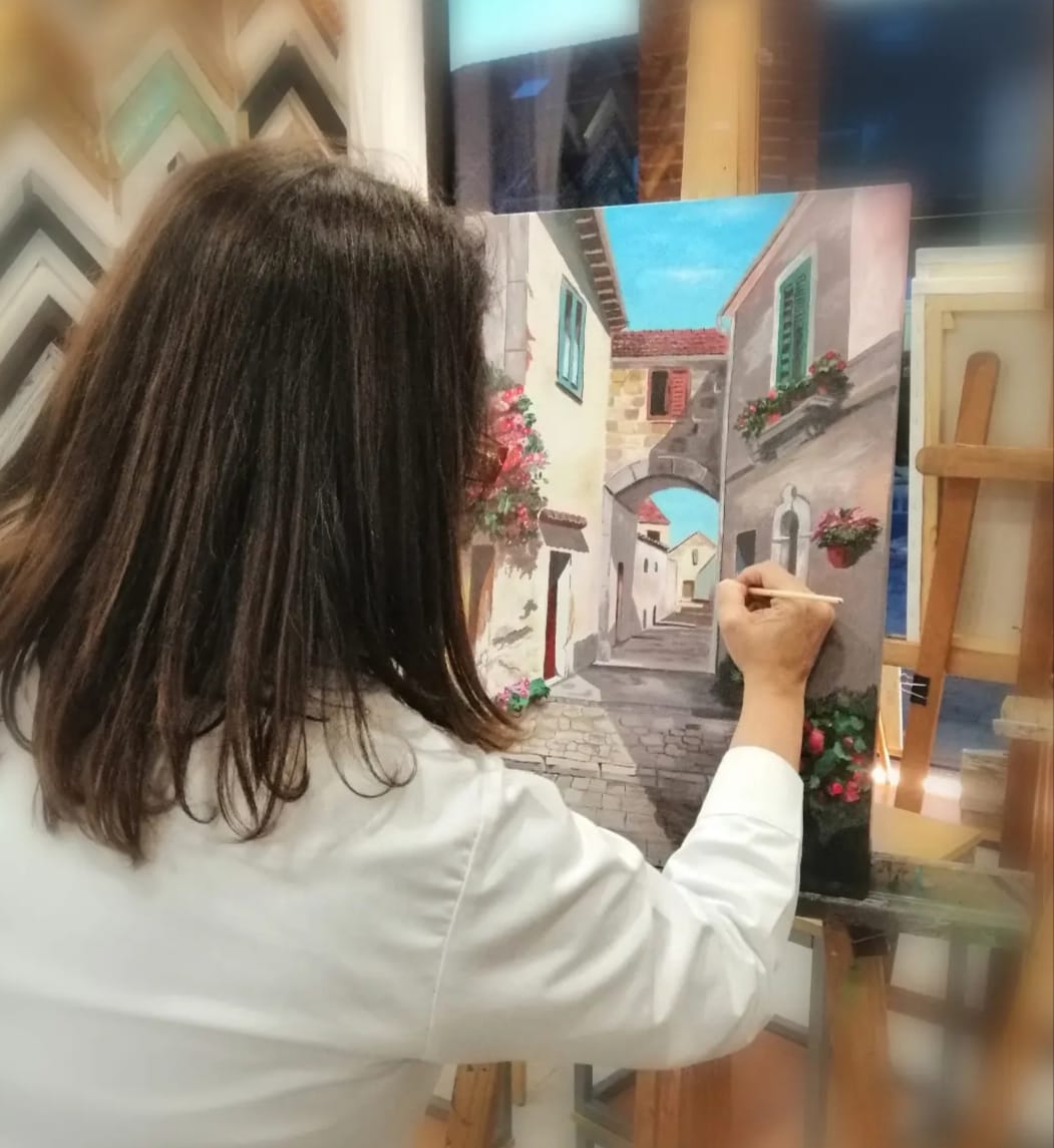 Alumna pintando calle mediterránea